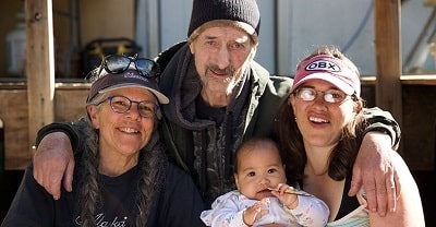 Talicia with her parents and her new born daughter.